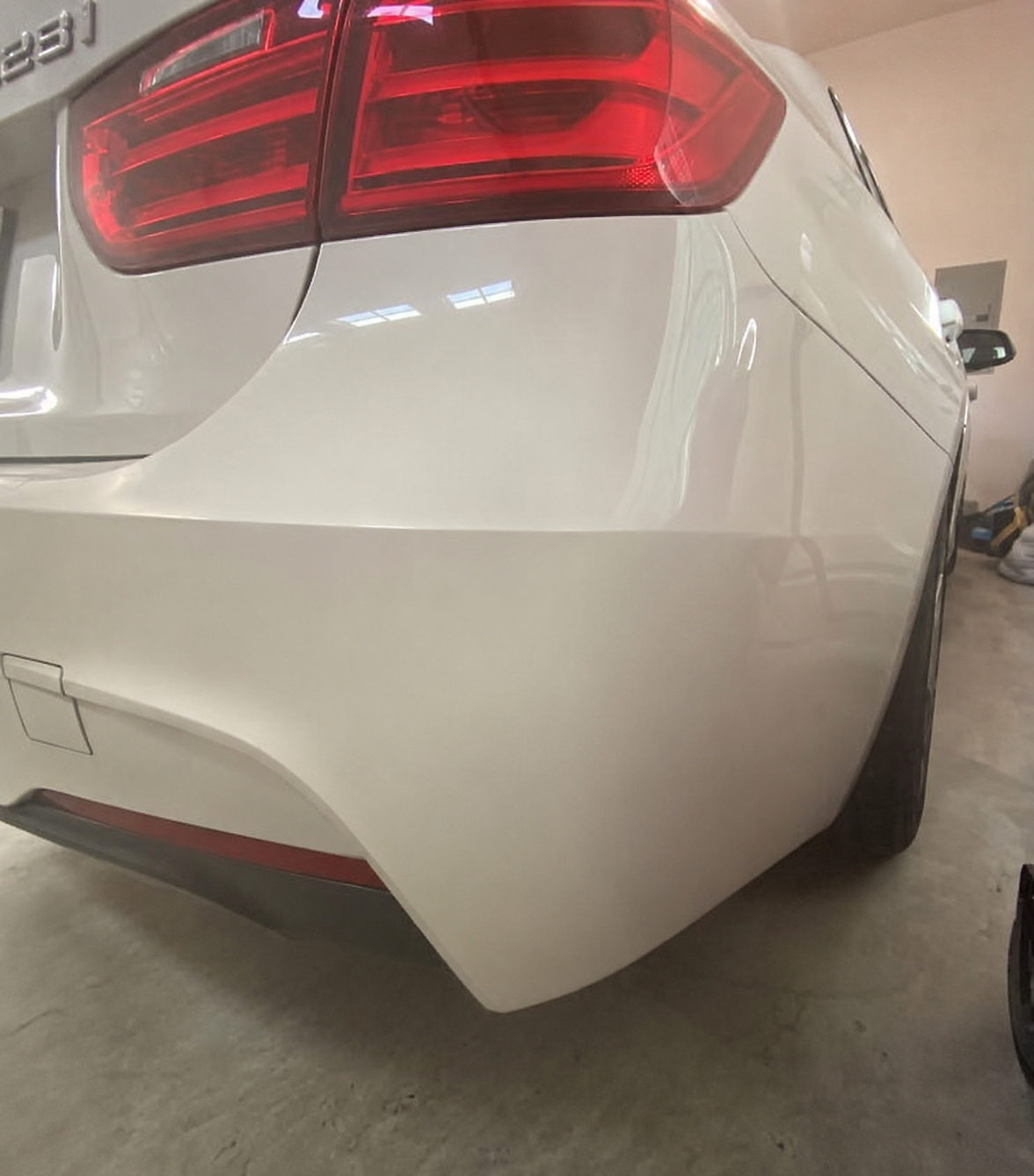 White BMW rear bumper damage after repair