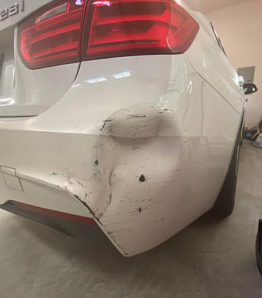 White BMW rear bumper damage before repair